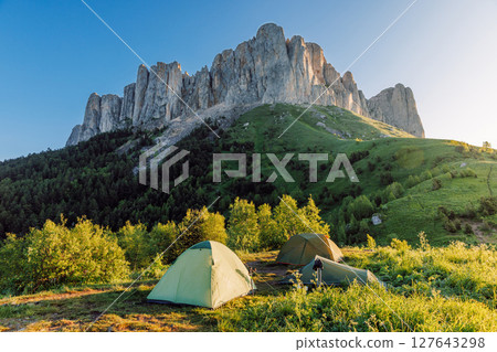 Camping spot in the mountains with a tent at sunrise, Bolshoy Tkhach national park 127643298