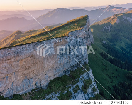 Drone view of Malyy Tkhach mount in Caucasus mountains with soft sunrise tones Drone view of Malyy Tkhach mount in Caucasus mountains with soft sunrise tones 127643302