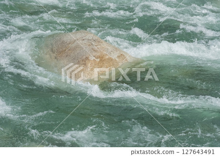 The raging torrent of a river swollen by rain (stock photo) 127643491