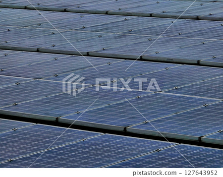 Solar panels arranged in rows, capturing sunlight for energy production. This renewable energy source promotes sustainability and reduces carbon footprint Solar panels arranged in rows, capturing sunlight for energy production. This renewable energy source promotes sustainability and reduces carbon footprint 127643952