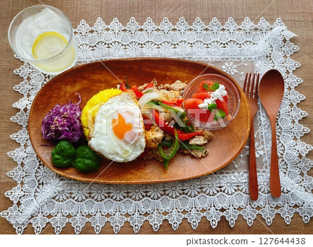 Asian plate lunch of turmeric rice and fried egg Asian plate lunch of turmeric rice and fried egg 127644438