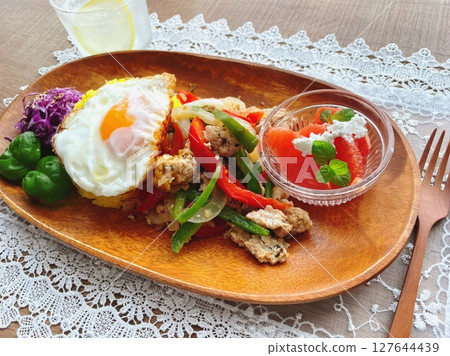 Asian plate with turmeric rice, fried egg and grapefruit Asian plate with turmeric rice, fried egg and grapefruit 127644439