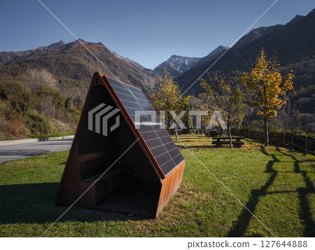 Solar panels integrated into a modern rest area structure, surrounded by autumn foliage in aosta, italy, with mountains in the background targnod Solar panels integrated into a modern rest area structure, surrounded by autumn foliage in aosta, italy, with mountains in the background targnod 127644888
