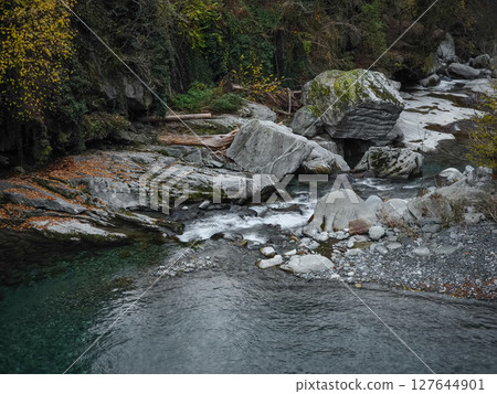 Winding river flowing through rocky landscape near aosta, cascading amid verdant autumn scenery with vibrant fall colors pontboset Winding river flowing through rocky landscape near aosta, cascading amid verdant autumn scenery with vibrant fall colors pontboset 127644901