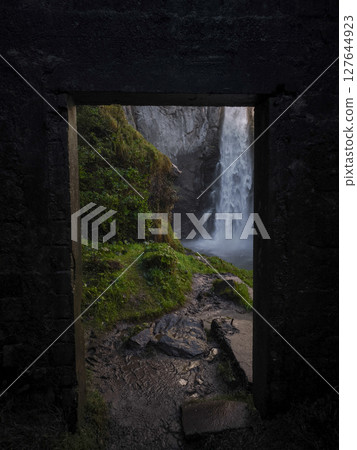 Stone archway framing verdant mountainside, cascading waterfall revealing scenic landscape in november aosta valley, italy Isollaz waterfall Stone archway framing verdant mountainside, cascading waterfall revealing scenic landscape in november aosta valley, italy Isollaz waterfall 127644923