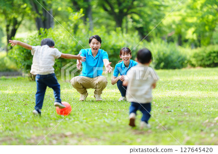 Nursery teacher providing outdoor childcare in the park 127645420