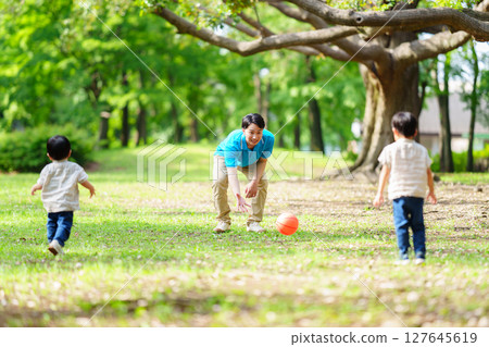 Nursery teacher providing outdoor childcare in the park 127645619