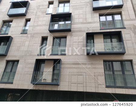 Modern panel building, featuring a geometric facade with warm tones at Budapest. 127645920