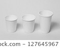 Paper glasses on a light background. 127645967