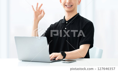 Smiling male seminar lecturer/instructor making an OK pose Smiling male seminar lecturer/instructor making an OK pose 127646357