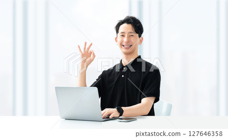 Smiling male seminar lecturer/instructor making an OK pose 127646358