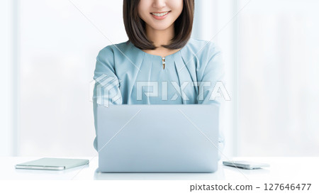 Smiling woman/businesswoman using a computer 127646477