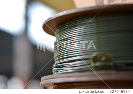 Plastic wire for 3d printer. Spools of plastic threads for printing on 3D printer. Spool of filament. Plastic for 3D printer. Components for 3D printing. New modern additive printing FDM technology Plastic wire for 3d printer. Spools of plastic threads for printing on 3D printer. Spool of filament. Plastic for 3D printer. Components for 3D printing. New modern additive printing FDM technology 127646984