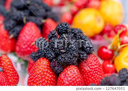 Assorted containers of berries for sale at a market. Fruits Assorted containers of berries for sale at a market. Fruits 127647051