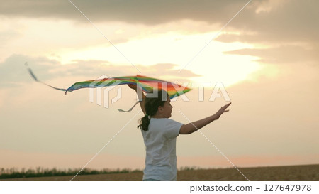 children flight airplane pilot sunset. concepts children running. little girl runs while holding flying kite her hands. schoolchild runs into fields wheat sunset. childhood village farm. child run children flight airplane pilot sunset. concepts children running. little girl runs while holding flying kite her hands. schoolchild runs into fields wheat sunset. childhood village farm. child run 127647978