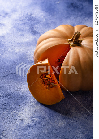Raw fresh cut pumpkin on dark background 127648084