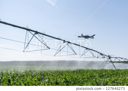 Drone controls pivot irrigation system on an agricultural field Drone controls pivot irrigation system on an agricultural field 127648273