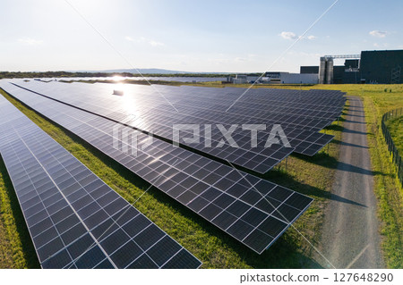 Modern green factory powered by renewable solar energy. Sustainable development in industry 127648290