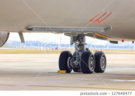 main landing gear of modern passenger aircraft taxi on taxi way. main landing gear of modern passenger aircraft taxi on taxi way. 127648477
