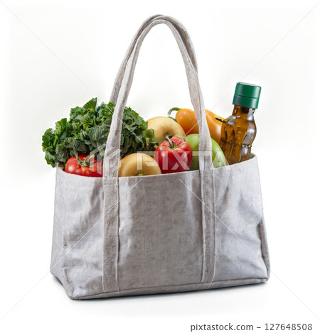 Eco-friendly shopping bag filled with fresh fruits and vegetables against a plain background 127648508