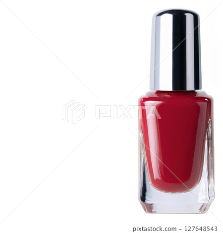 Bright red nail polish in a sleek bottle displayed on a clean surface Bright red nail polish in a sleek bottle displayed on a clean surface 127648543