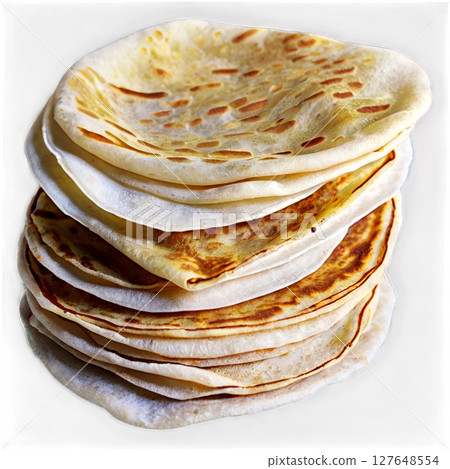 Soft and golden flatbreads stacked on a white surface, ready for serving at a meal 127648554