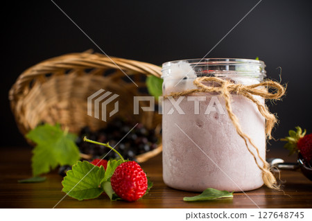Sweet ice cream with berries on wooden background Sweet ice cream with berries on wooden background 127648745