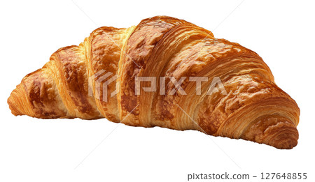 Freshly baked croissant resting on a surface, showcasing its flaky layers and golden color 127648855