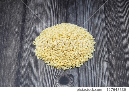 Raw Organic Stelline Pasta in a Bowl, top view. Flat lay, overhead, from above. Macaroni stars. Star shaped noodles. 127648886
