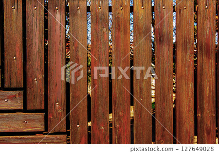 Wooden fence. Torn the wooden panels. Pattern interior design. Decorative fence. Material board. Background. 127649028