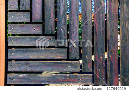 Wooden fence. Torn wooden panels. Pattern interior design. Decorative fence. Material is board. Background. 127649029