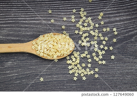 Raw Organic Stelline Pasta in a Bowl, top view. Flat lay, overhead, from above. Macaroni stars. Star shaped noodles. Raw Organic Stelline Pasta in a Bowl, top view. Flat lay, overhead, from above. Macaroni stars. Star shaped noodles. 127649060