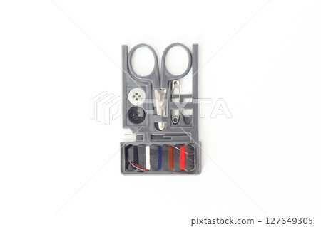Small Sewing Kit with Needles, Multicolored Threads, scissors, Pin and Buttons isolated on white 127649305