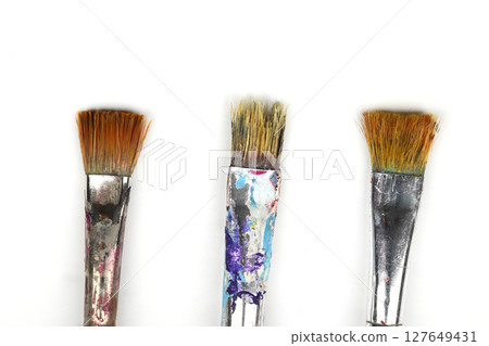 Artistic brushes close up. Watercolor paints in the background. Background with brushes and paints. 127649431
