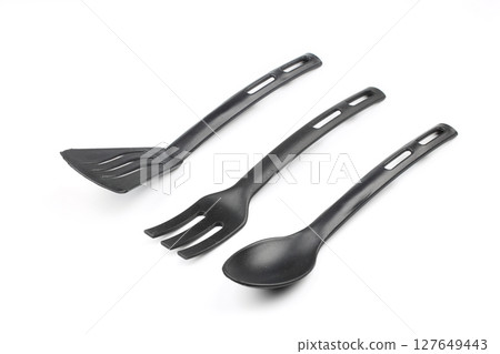 Black plastic kitchen spatula and spoon isolated on white background Black plastic kitchen spatula and spoon isolated on white background 127649443