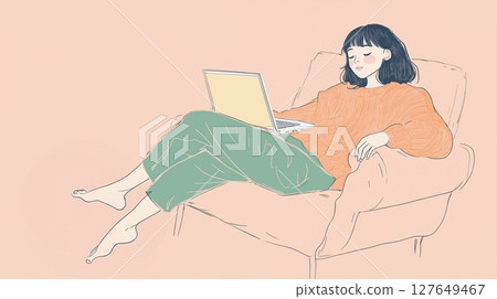 Young woman working on laptop in cozy chair during afternoon at home 127649467