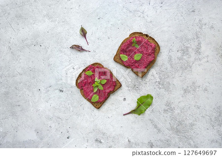 Beetroot Spread Generously Served on Grain Toast with Fresh Herbs 127649697