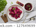 Vibrant Beetroot Dish, Artfully Presented with Herb Garnish and Crisp Crackers 127649699