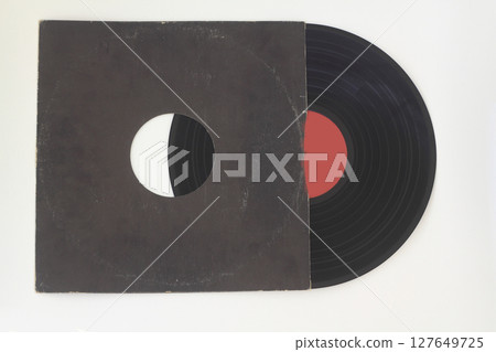 Aged black paper cover and vinyl record isolated on white background Aged black paper cover and vinyl record isolated on white background 127649725