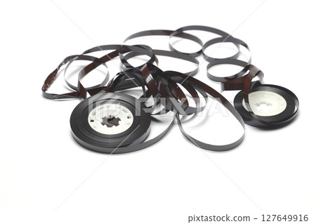 Old cassette with unwound tape. Damaged data medium for old sound recording devices 127649916