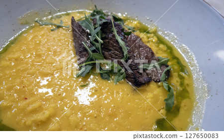 Plate of hearty pea soup with smoked meat served with bread. Plate of hearty pea soup with smoked meat served with bread. 127650083
