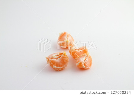 Ripe mandarin with leaves close-up on a white background. Tangerine orange with leaves on a white Ripe mandarin with leaves close-up on a white background. Tangerine orange with leaves on a white 127650254