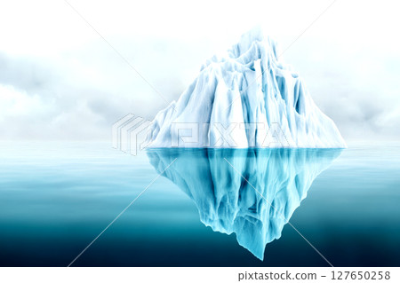 Large iceberg displays intricate ice formations with two thirds submerged under clear, tranquil waters, reflecting a serene sky above 127650258