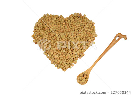 Green lentils in wooden bowl on isolated white background. Top view, copy space. Flat lay. 127650344