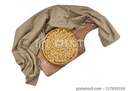 Green lentils in wooden bowl on isolated white background. Top view, copy space. Flat lay. Green lentils in wooden bowl on isolated white background. Top view, copy space. Flat lay. 127650350