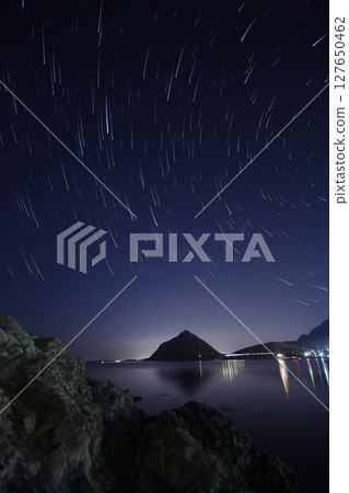 A view of the stars of the Milky Way with a mountain top in the foreground.Perseid Meteor Shower observation 127650462