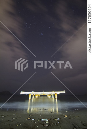 A view of the stars of the Milky Way with a mountain top in the foreground.Perseid Meteor Shower observation 127650494
