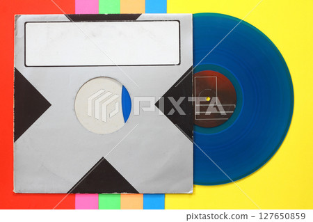 Aged black paper cover and blue vinyl LP record isolated on colorful background Aged black paper cover and blue vinyl LP record isolated on colorful background 127650859