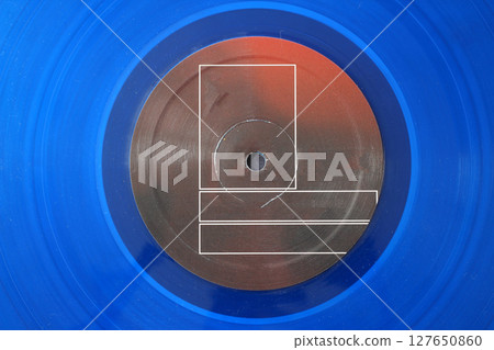 12-inch LP vinyl record disk with blank red label. Close-up shot, top view 12-inch LP vinyl record disk with blank red label. Close-up shot, top view 127650860