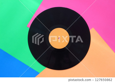 Black Vinyl record on a colorful background. Retro style. Top view. 127650862